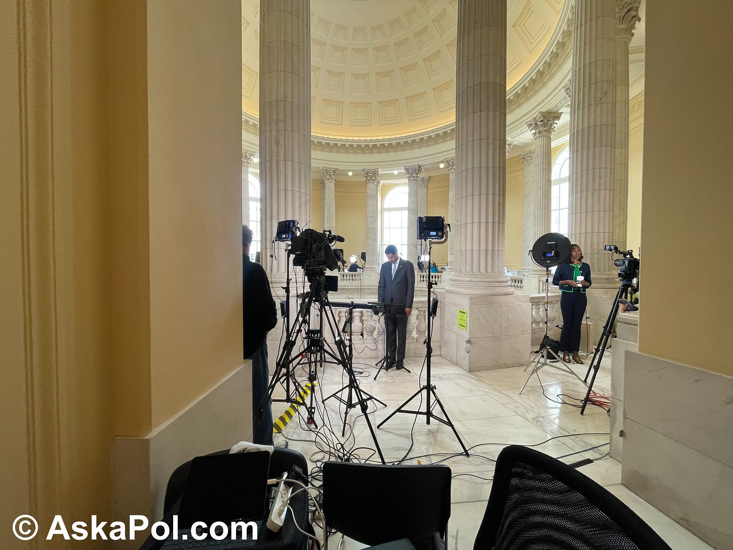 A reporter and political speak into cameras Photo MATT LASLO © Ask a Pol 