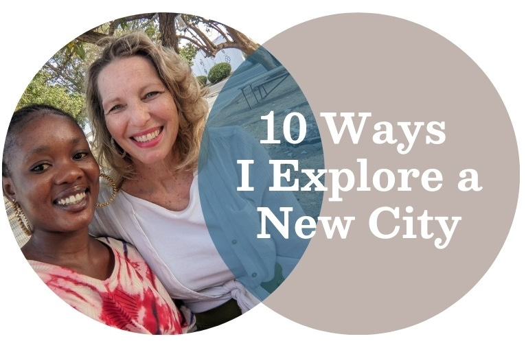 A young black woman and a white woman are hugging each other and smiling. 