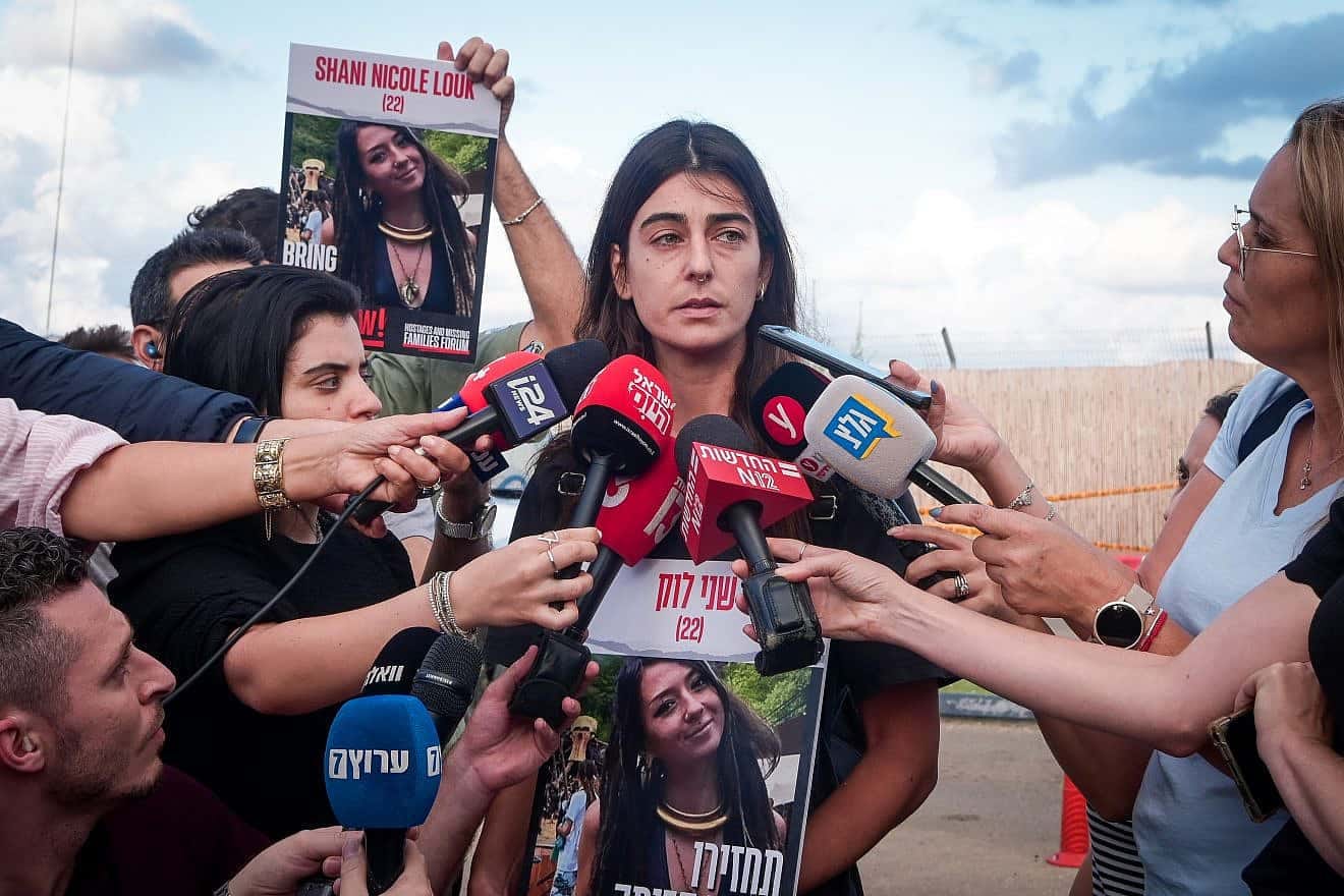 A cousin of Shani Louk, who was first thought abducted by Hamas terrorists in the attacks on Oct. 7 but later revealed to have been one of 1,400 people murdered that Saturday morning in southern Israel, speaks to the media outside the Home Front Command base in Ramla on Oct. 15, 2023. Photo by Avshalom Sassoni/Flash90. A cousin of Shani Louk, who was first thought abducted by Hamas terrorists in the attacks on Oct. 7 but later revealed to have been one of 1,400 people murdered that Saturday morning in southern Israel, speaks to the media outside the Home Front Command base in Ramla on Oct. 15, 2023. Photo by Avshalom Sassoni/Flash90.