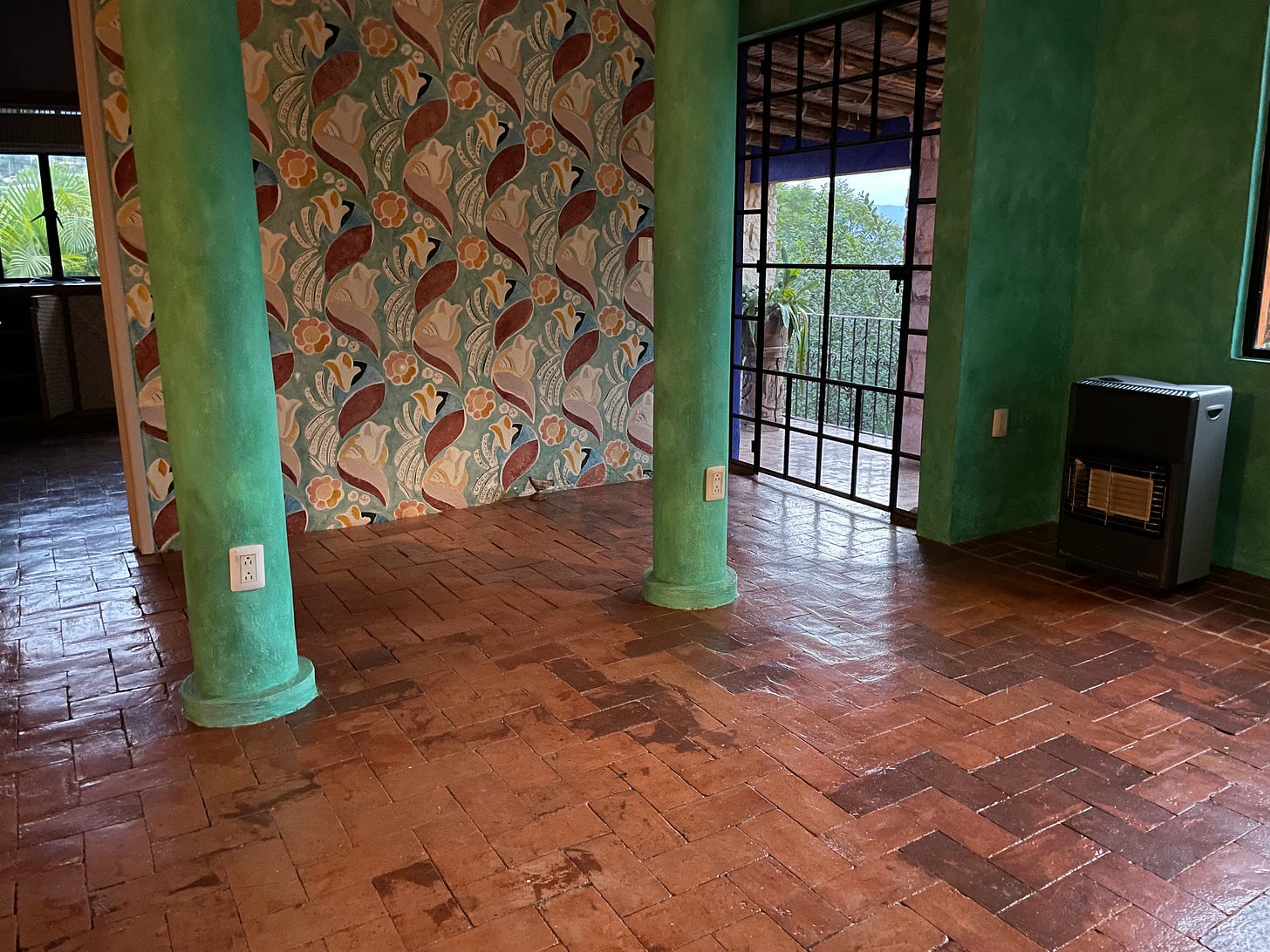 A room with a mottled brick floor.