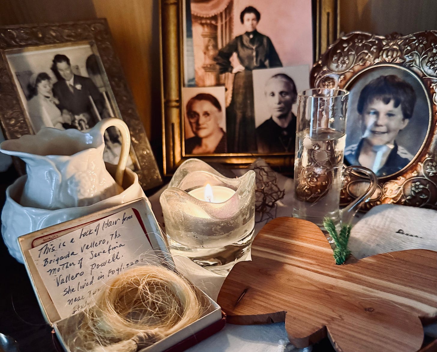 Photos of my parents, grandmothers, and son on my daily ancestor altar. Photo by JPC.