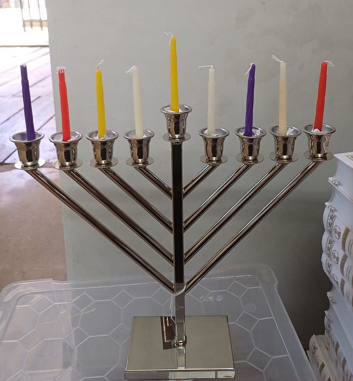 Two hanukiot (menorahs), one with the shammash plus one candle per Hillel, the second the shammash plus 8 candles per Shammai