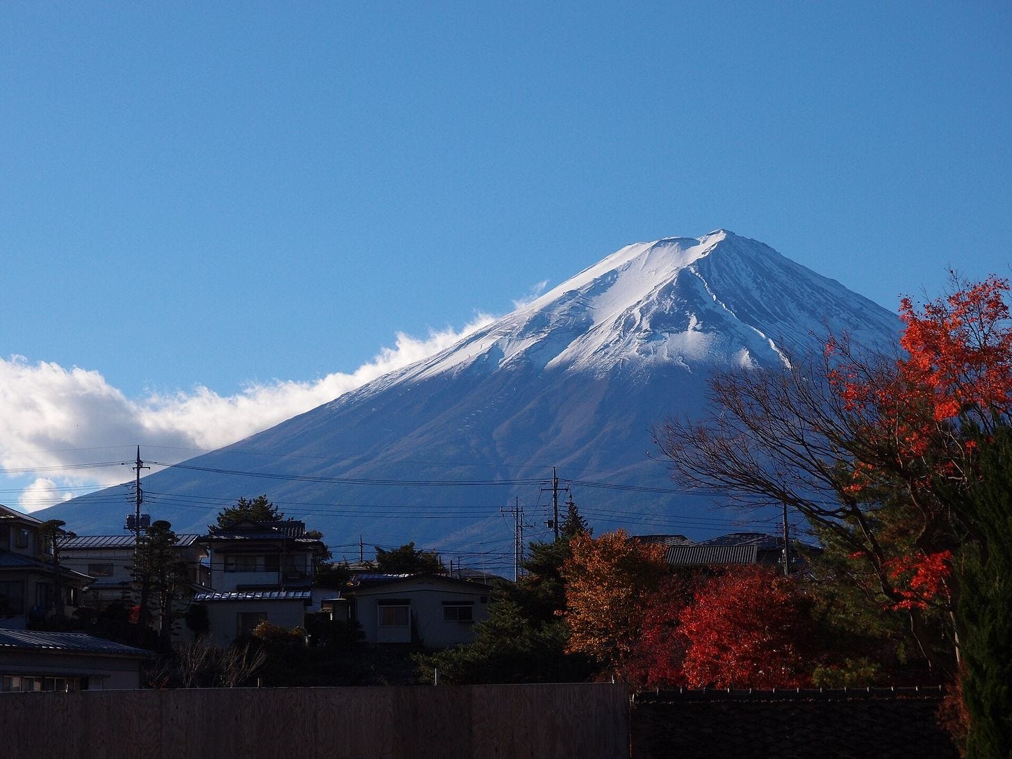 Snow-capped Mount Fuji rising over the town at Lake Kawaguchiko