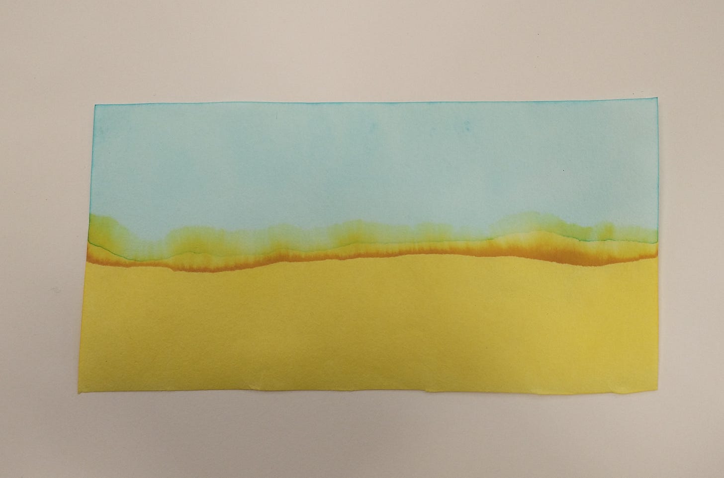 Photo of artwork with blue across the top, brownish orange across the middle, and yellow at the bottom