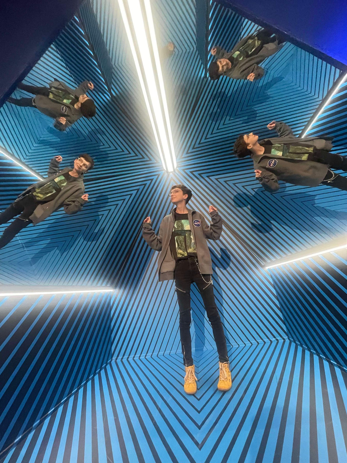 Beck at the museum of Illusions, reflected five times in mirrors with a sort of psychadelic effect, dancing like an awkward dad while wearing a Nasa jacket and a Vincent Van-Gough tee shirt