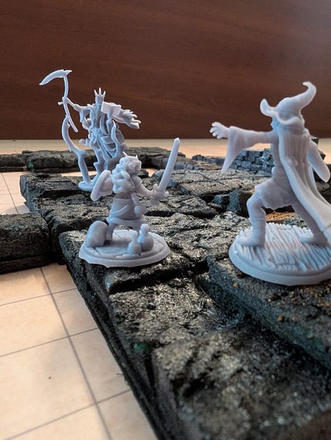 3 photos of dungeon tiles, walls, stairs, and miniatures. 1 showing all the pieces laid out, 1 showing a sample map, and 1 showing a dynamic combat on the tiles.