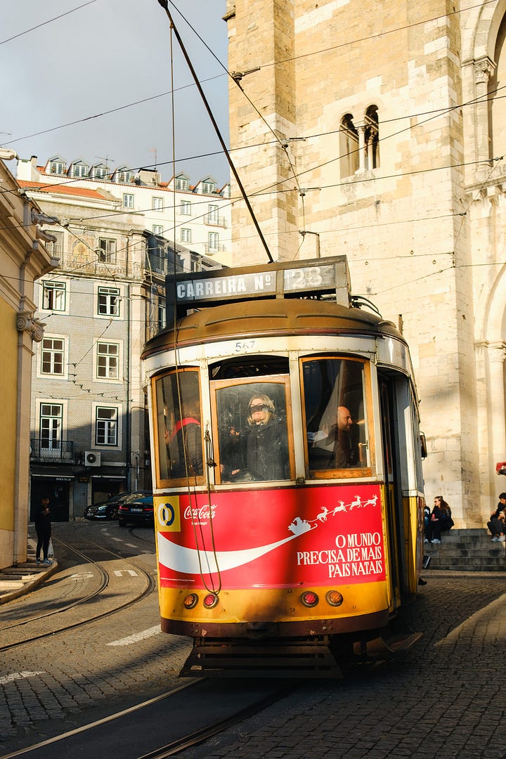 Yellow trams on the streets of Alfama, Lisbon