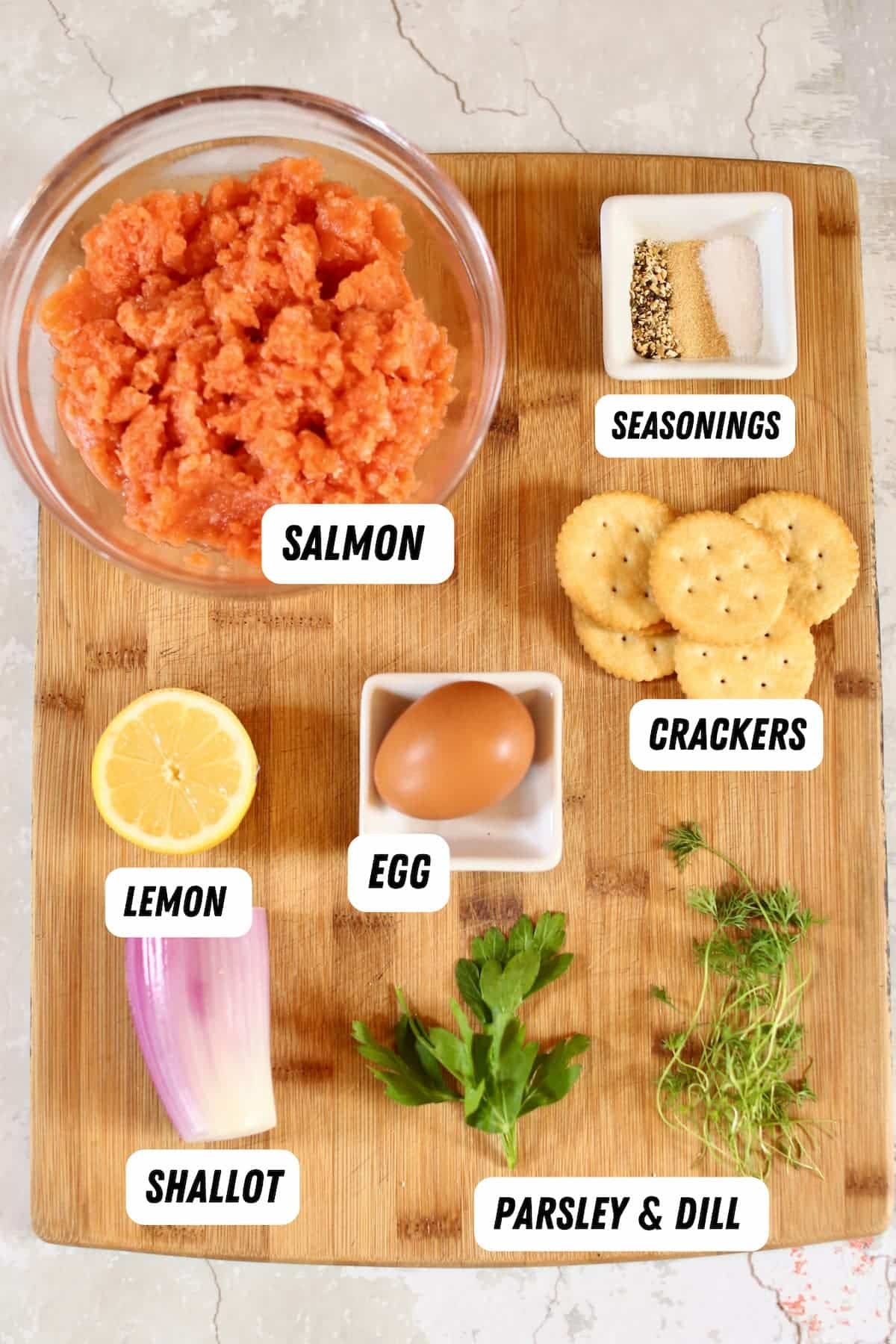 a cutting board of ingredients that are labeled in black and white.