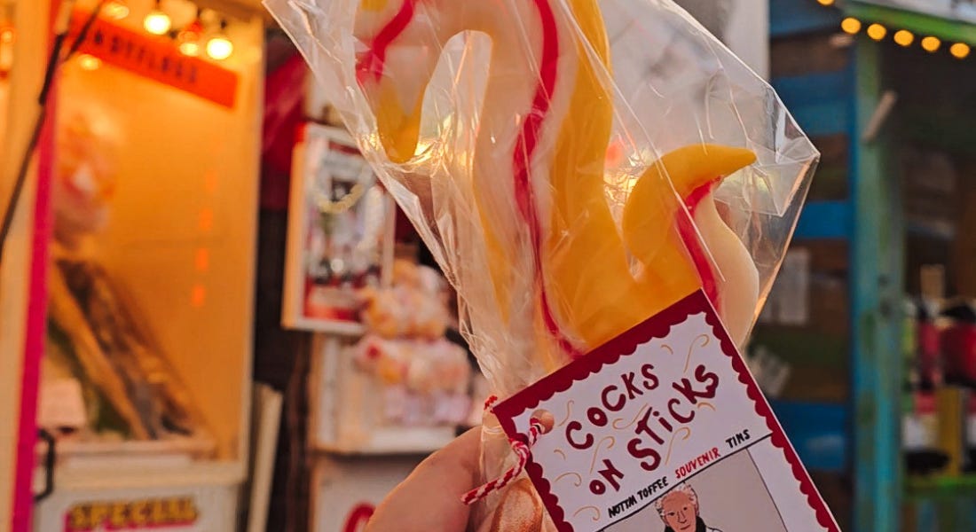 A lollipop with yellow and pink rock and stalls behind it