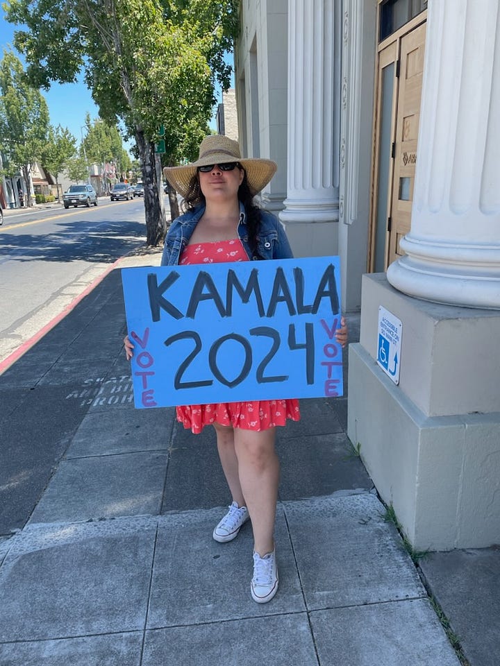 Woman with posters supporting Kamala Harris for President