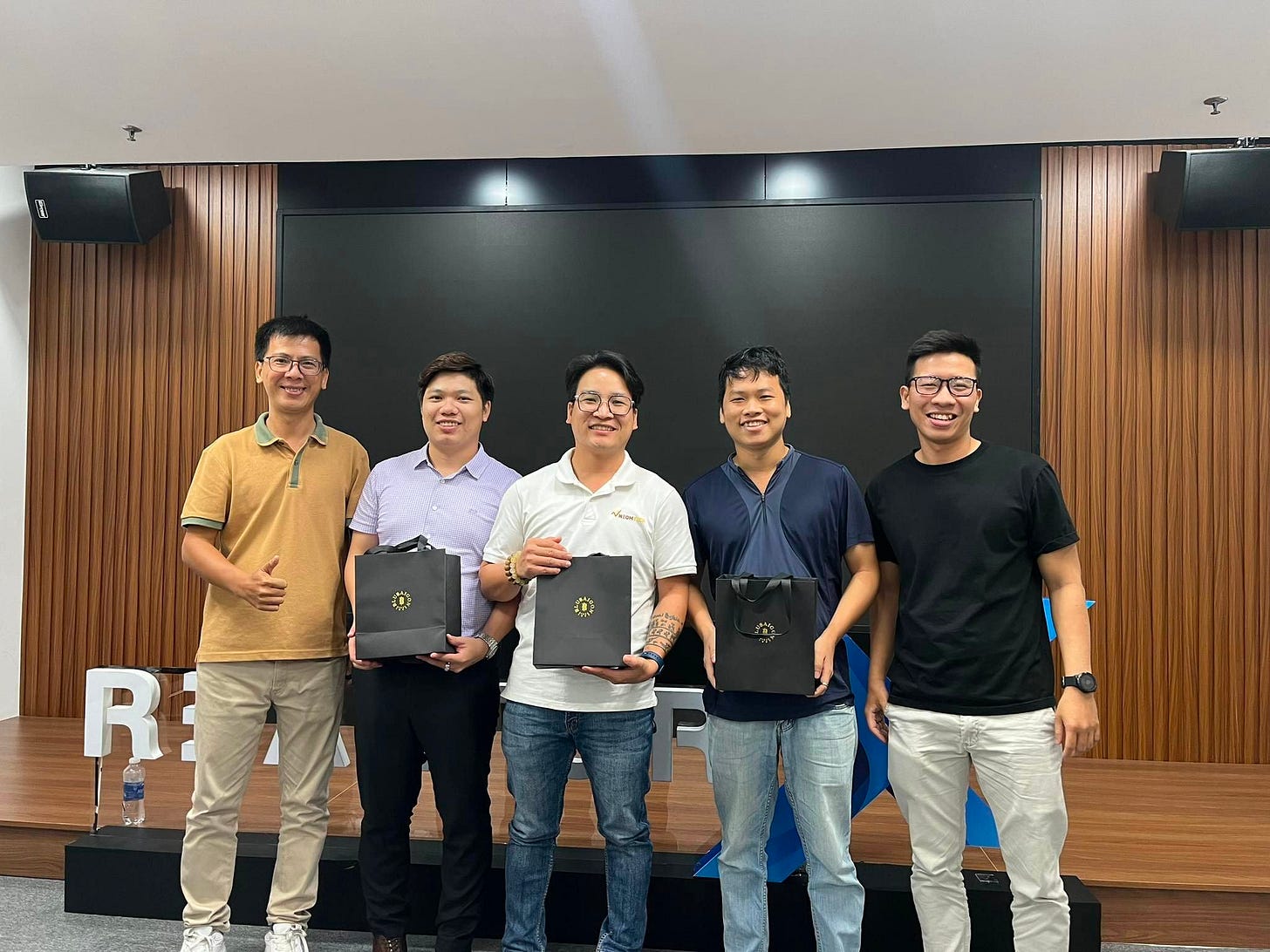 May be an image of 5 people, people standing, wrist watch and indoor