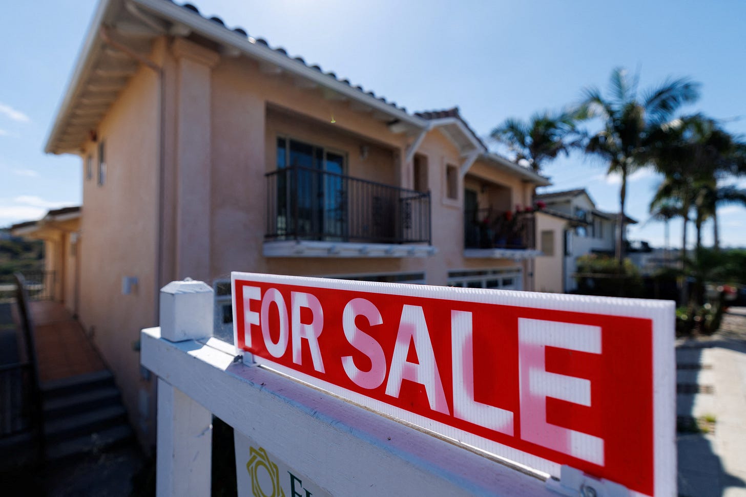 A residential home for sale sign is shown in California