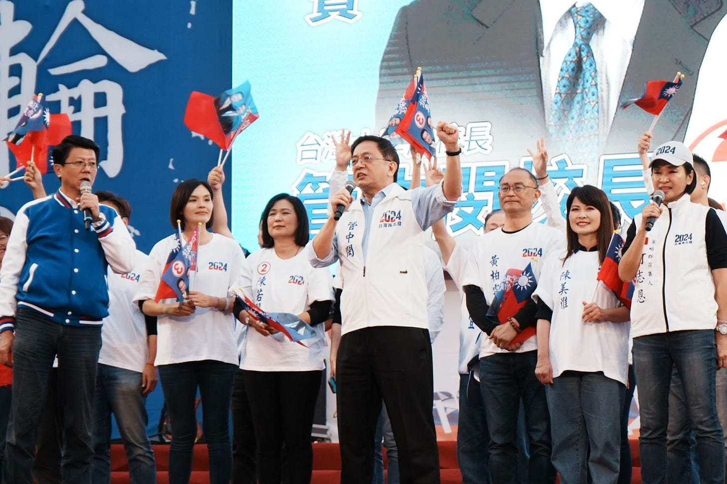 A group of people holding flags

Description automatically generated