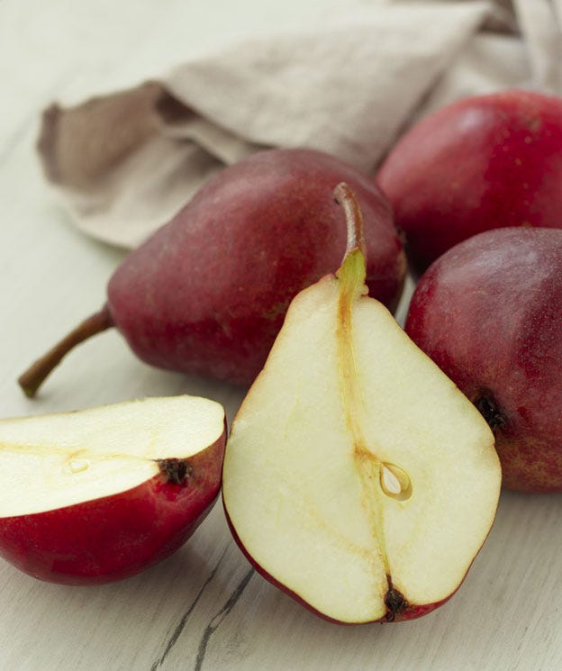 four anjou pears, one is cut in half