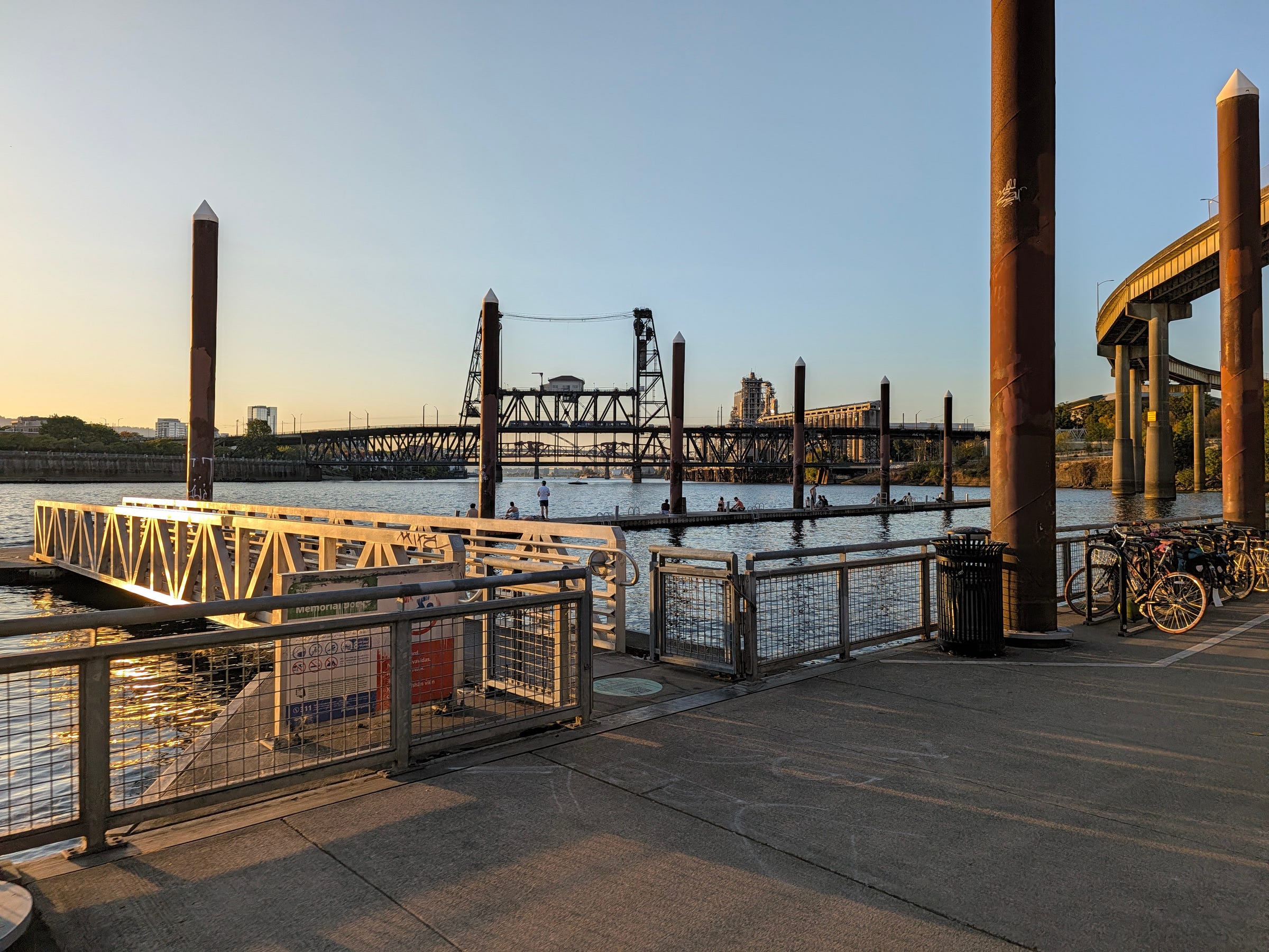 Sunset over docs with swimmers lounging and the Steel Bridge in the background. Sunset over docs with swimmers lounging and the Steel Bridge in the background.