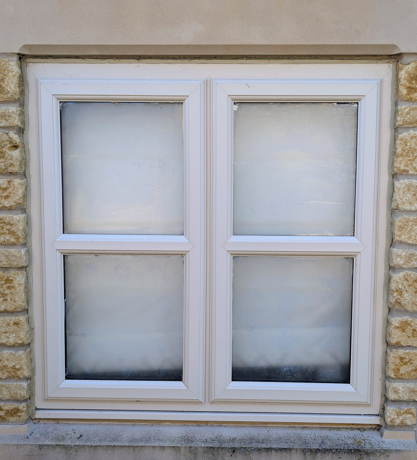 A window painted in yogurt. It is barely perceptable. 