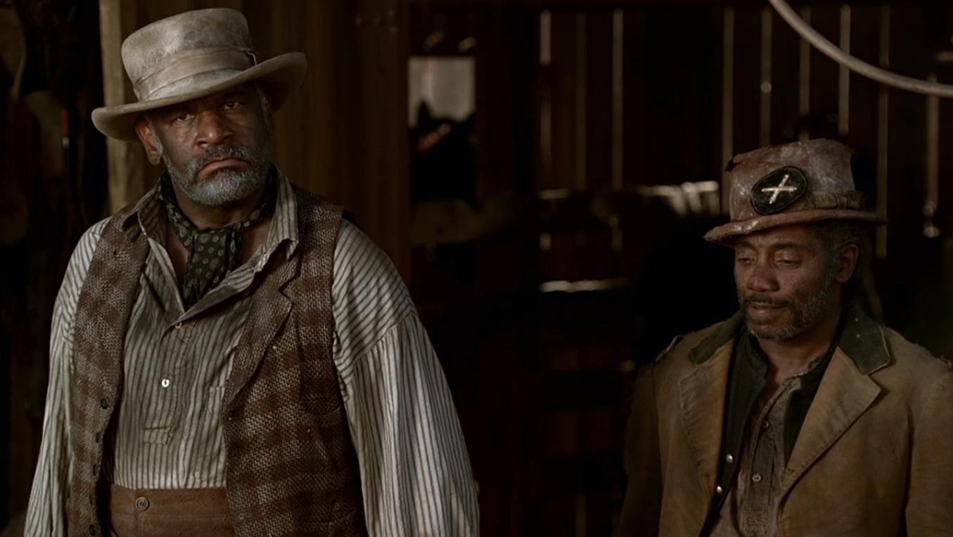 This image shows livery owner Hostetler (played by Richard Gant) on the left and his friend Samuel Fields (played by Franklin Ajaye) on the right. Both men stand in the entrance to Hostetler's stable. This image shows livery owner Hostetler (played by Richard Gant) on the left and his friend Samuel Fields (played by Franklin Ajaye) on the right. Both men stand in the entrance to Hostetler's stable.