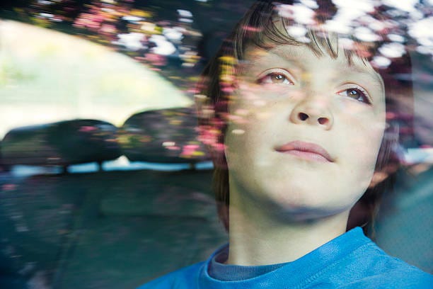 boy aged 10 in car. - boy looking out car window stock pictures, royalty-free photos & images