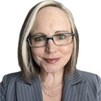 A person wearing glasses and a suit

AI-generated content may be incorrect.