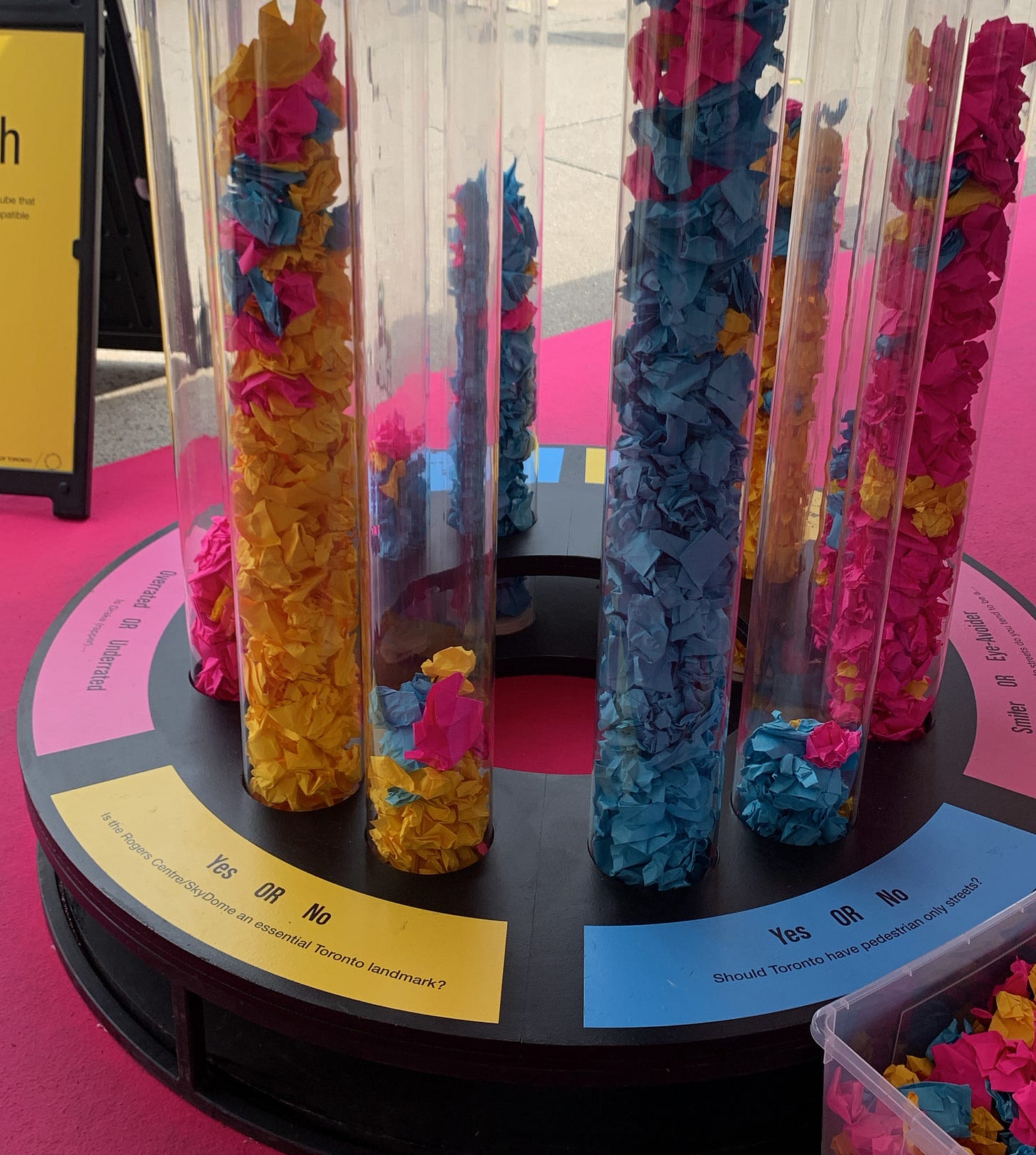 Plastic tubes filled with crumpled paper that let people vote yes or no to a specific question or idea.