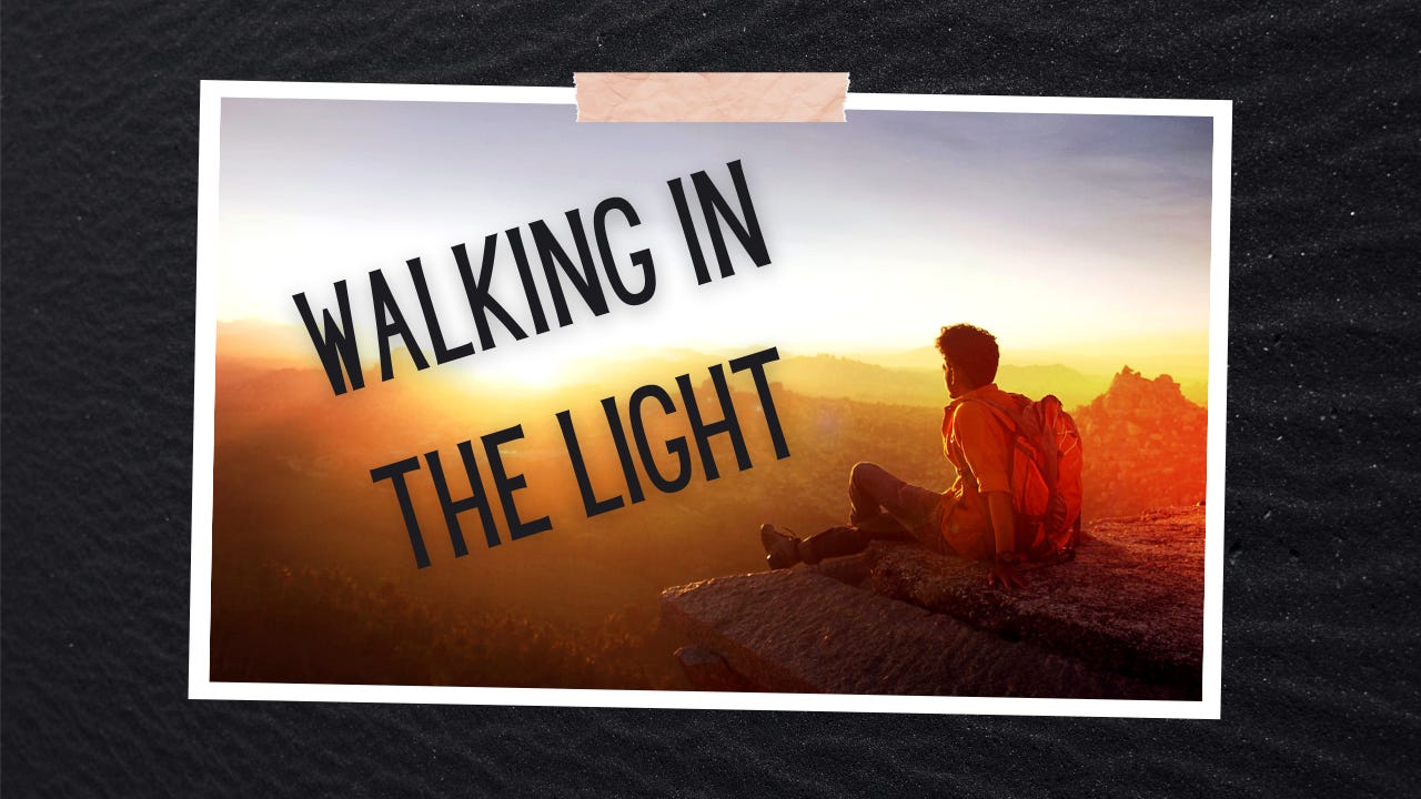 A man sitting on a mountain with the words "Walking in the Light."