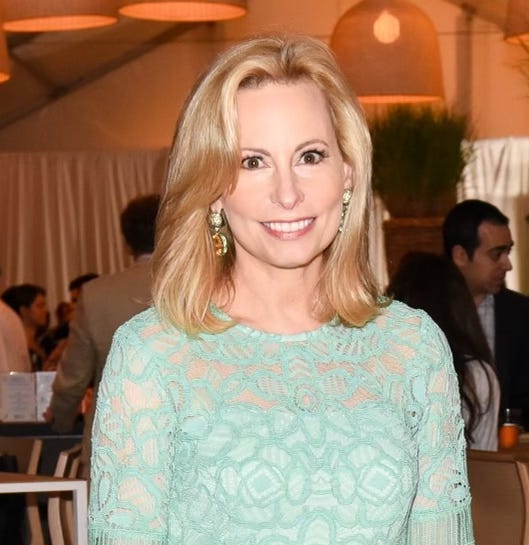 Beautiful woman with blond hair and mint green dress.  Gillian Miniter.