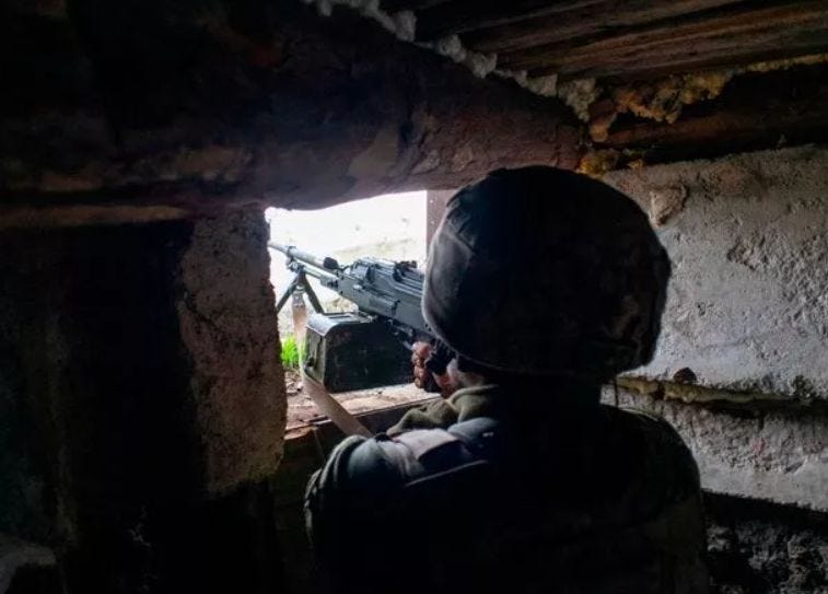 A Ukrainian machine gun position looks onto Russian troops 