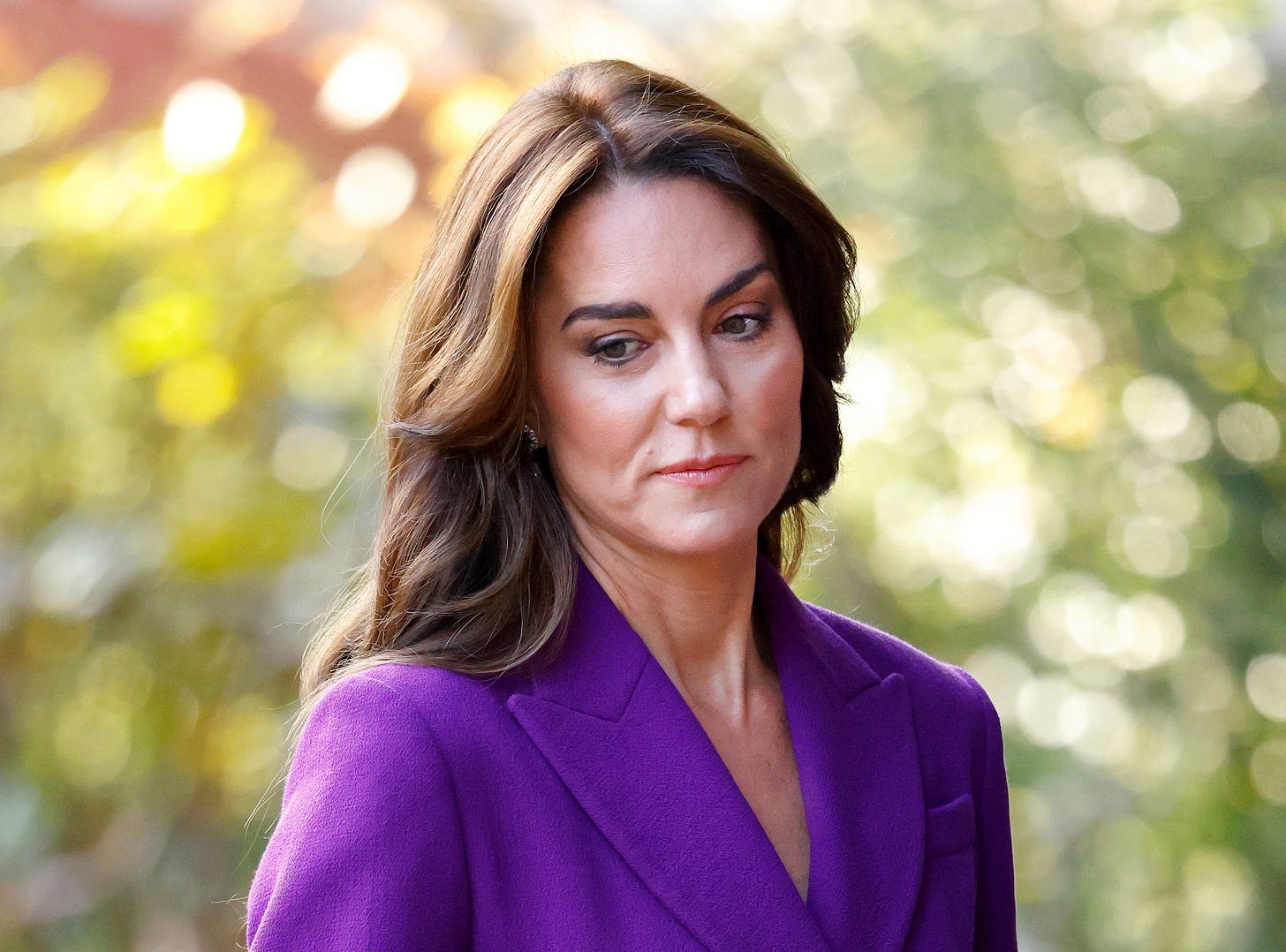 kate middleton looking sad wearing purple jacket