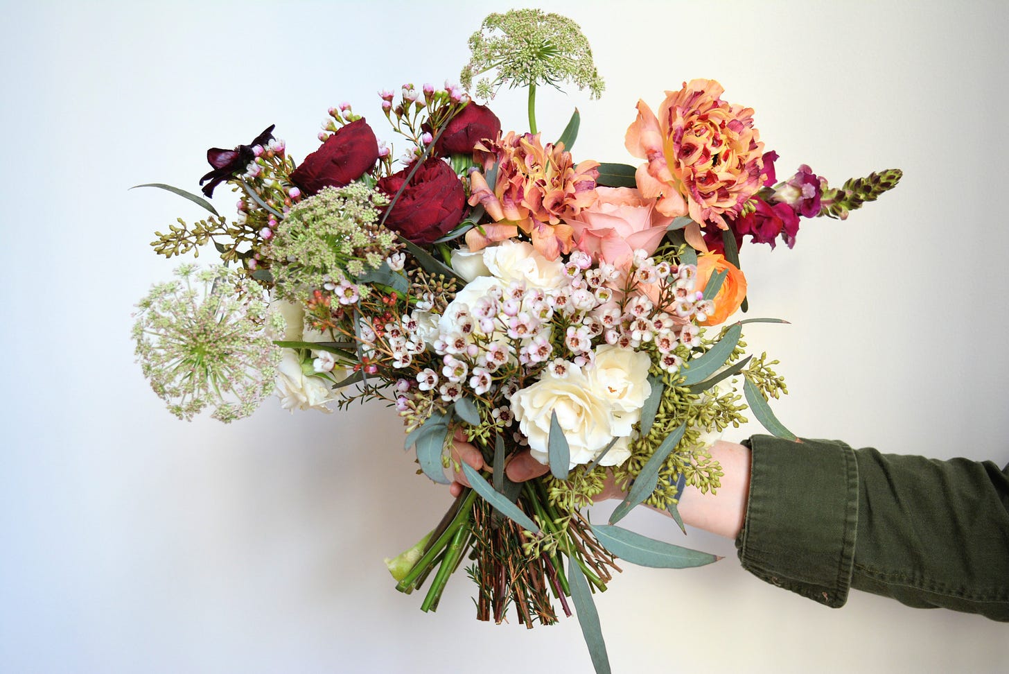 hand holding a bouquet of flowers