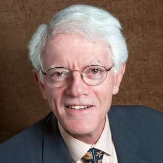 Professional portrait of an older man in business attire, suitable for illustration in investing-related content