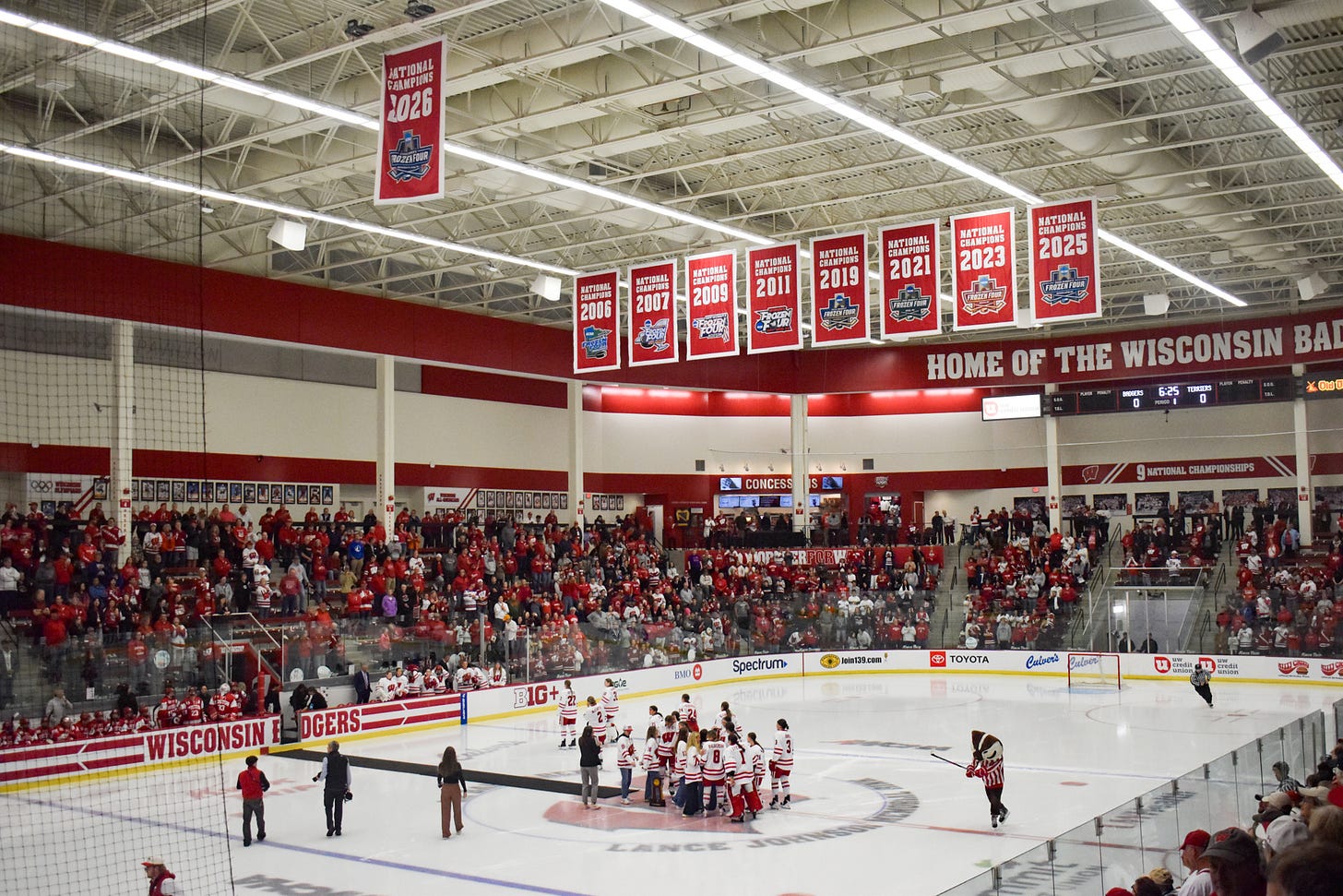 Fans standing around LaBahn Arena as the 2026 banner sits alone with the other eight in the background of the rafters