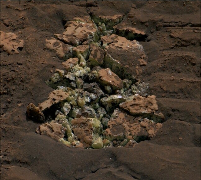 These yellow crystals were revealed after NASA’s Curiosity happened to drive over a rock and crack it open on May 30. Using an instrument on the rover’s arm, scientists later determined these crystals are elemental sulfur Credit: NASA/JPL-Caltech/MSSS These yellow crystals were revealed after NASA’s Curiosity happened to drive over a rock and crack it open on May 30. Using an instrument on the rover’s arm, scientists later determined these crystals are elemental sulfur Credit: NASA/JPL-Caltech/MSSS