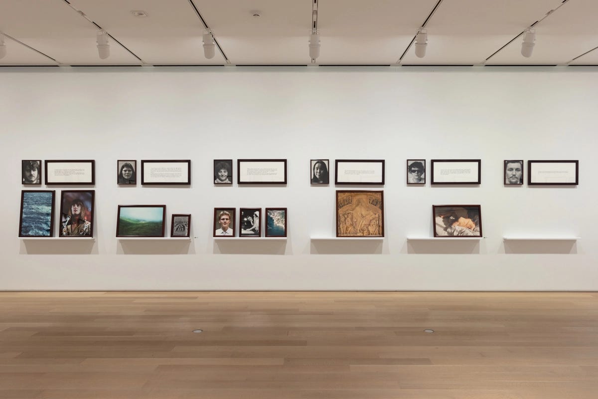 Groupings of photos and texts arranged in rows and on wall-mounted shelves. Groupings of photos and texts arranged in rows and on wall-mounted shelves.