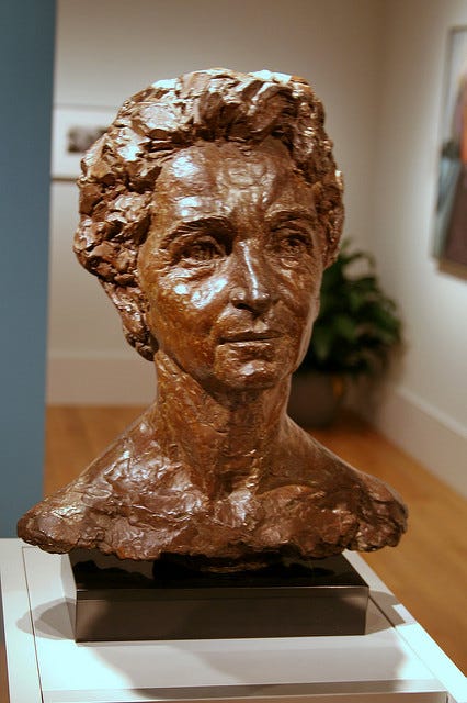 A bronze bust of Margaret Sanger under museum lighting. A bronze bust of Margaret Sanger under museum lighting.