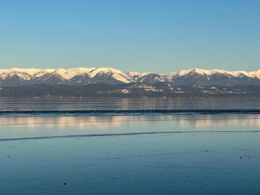 A body of water with mountains in the background

Description automatically generated