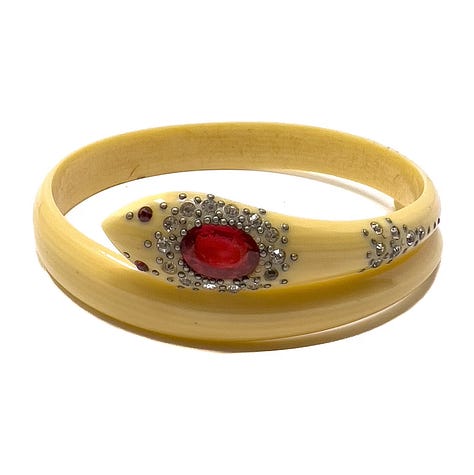 Stylized snake forms beginning in horn or shell are remade in early plastic approximations of natural materials.