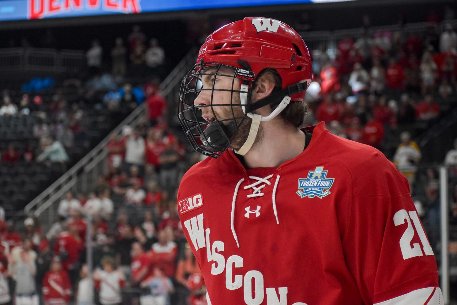 Wisconsin sophomore Ryan Botterill looks left wearing red road Wisconsin jersey with 2026 frozen four patch.