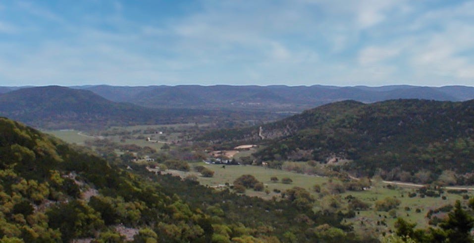 A view across the Texas hills against a blue sky.