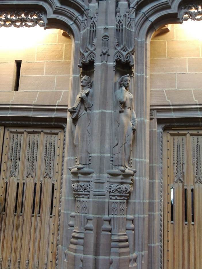 A stone pillar with a statue on it

AI-generated content may be incorrect.