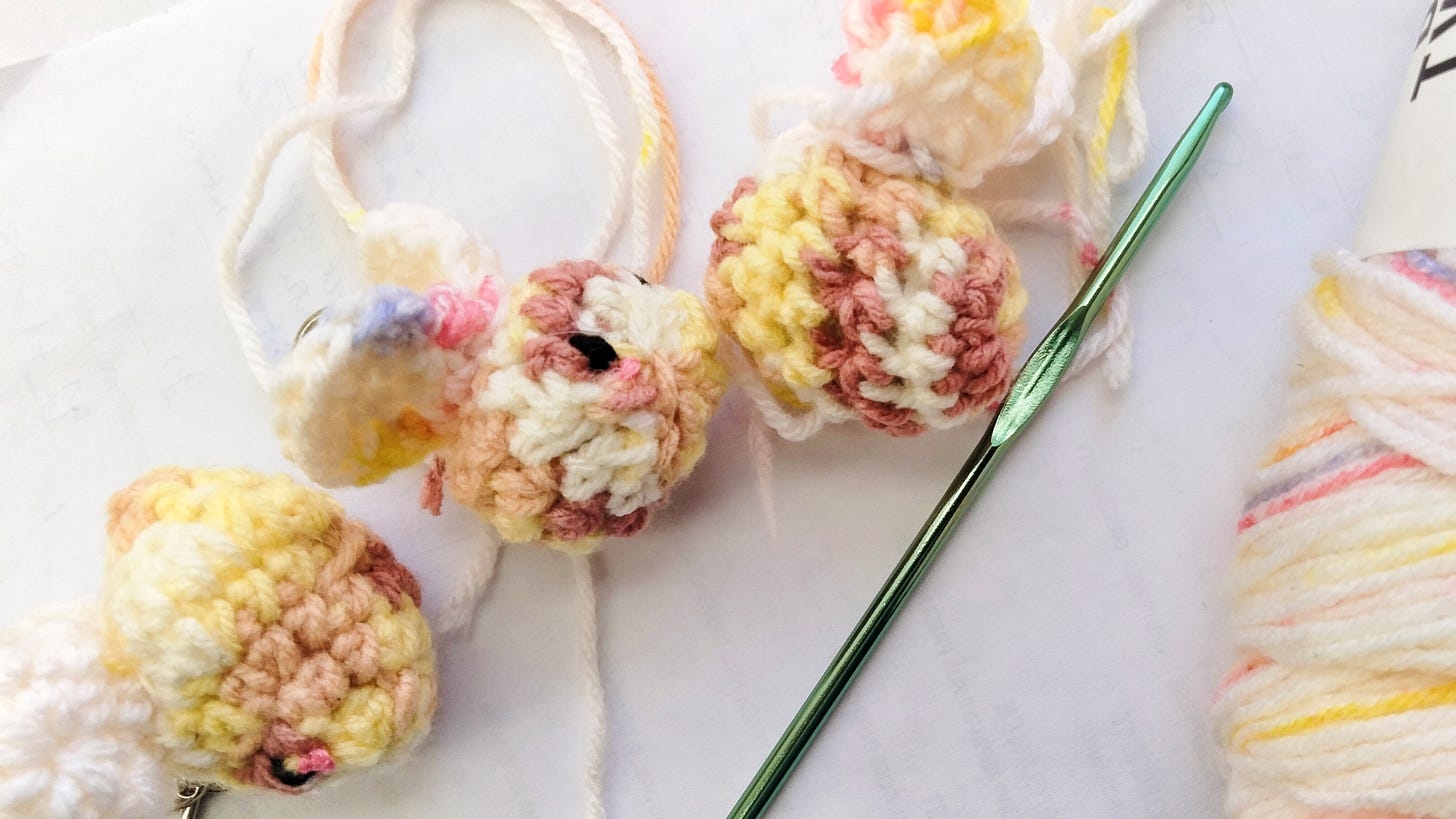 Bee keychains, crochet hook, yarn