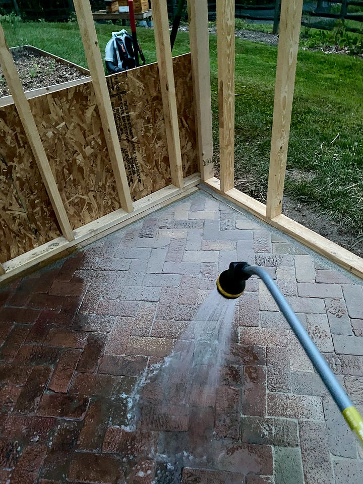 Mosaic of a brick paver floor being installed.