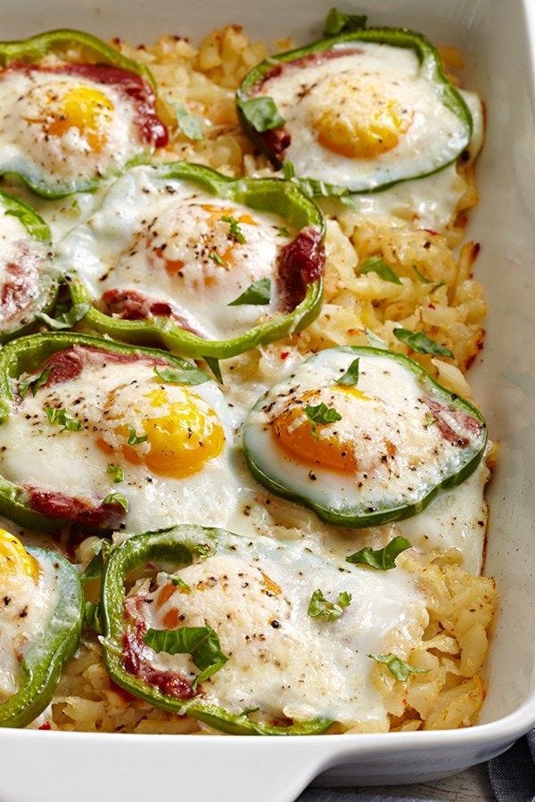 This may contain: a casserole dish with eggs and peppers