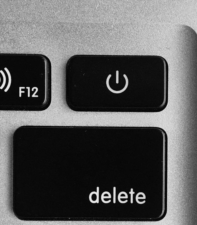 selective focus photo of black and white delete, enter, power button, and F12 computer keys