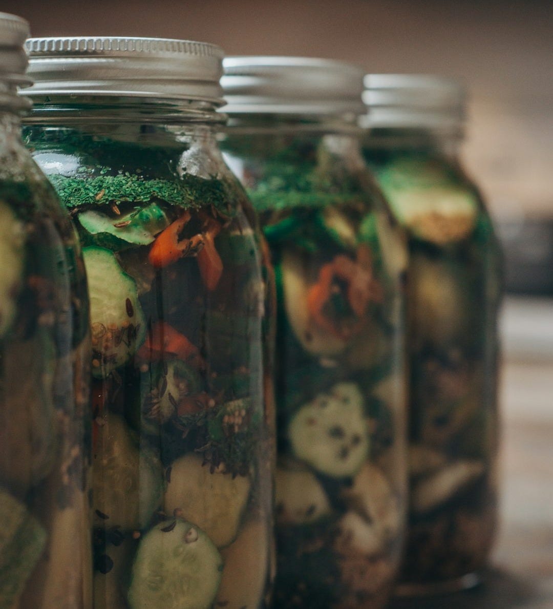 a group of fish in glass jars