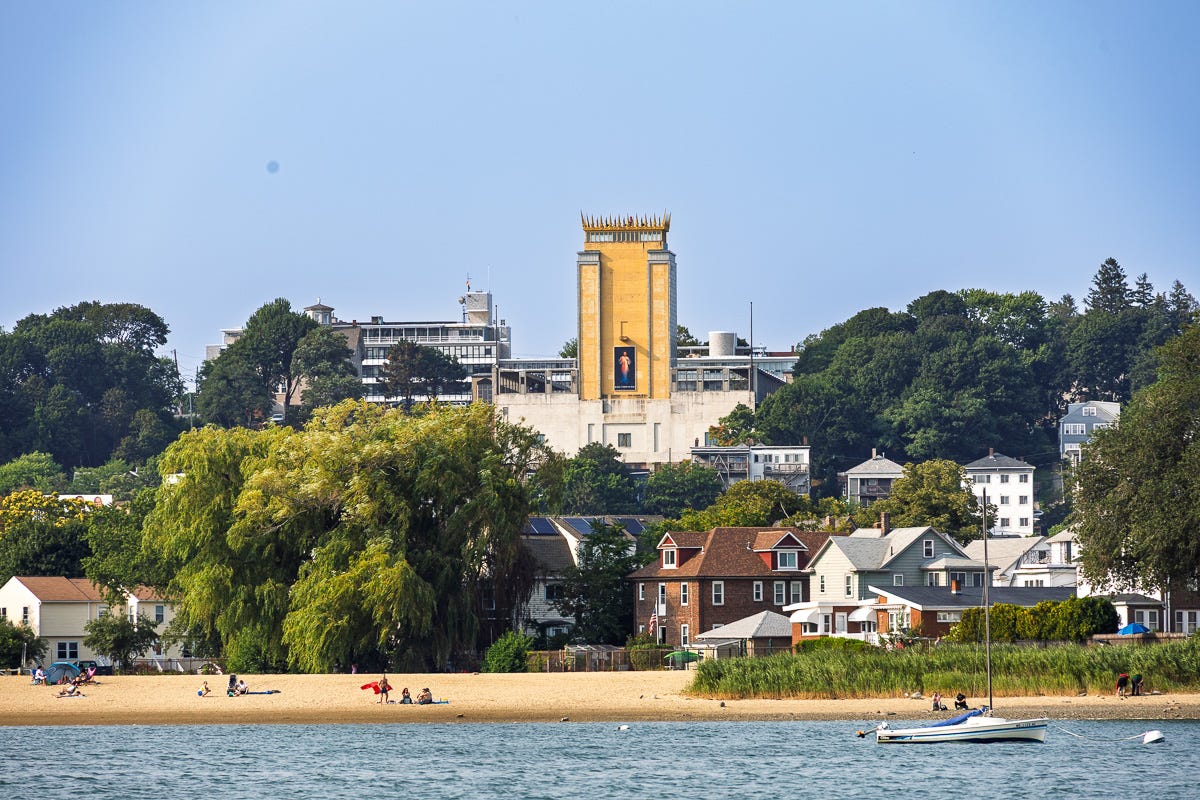 Madonna Queen of the Universe Shrine tower with gold crown, East Boston landmark seen from Boston Harbor near Logan Airport Madonna Queen of the Universe Shrine tower with gold crown, East Boston landmark seen from Boston Harbor near Logan Airport