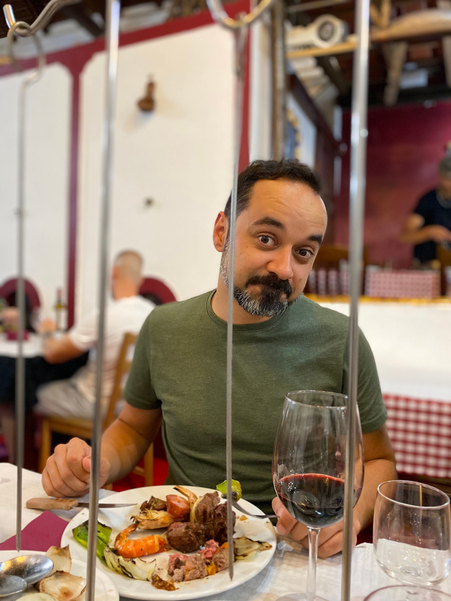 Tiago Cruz eating dinner with a nice glass of red wine