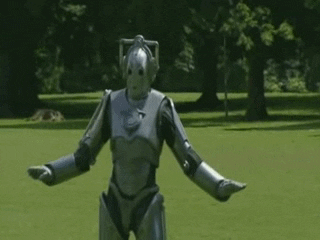 A Doctor Who Cyberman dances in a park