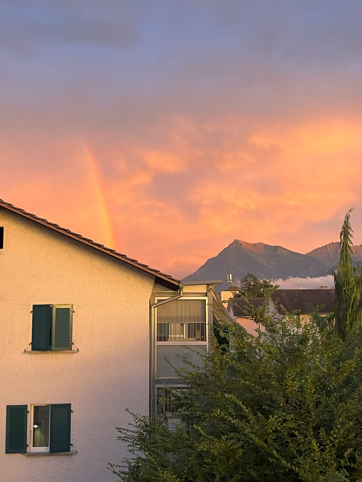 a rainbow after a storm over the swiss mountains