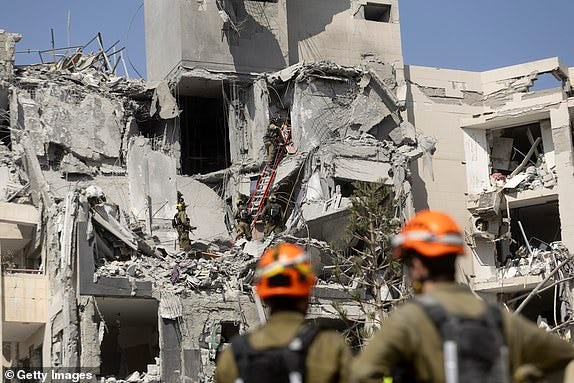 BEER SHEVA, ISRAEL - JUNE 24: Emergency and rescue responders work to recover human bodies at the rubble of a building after a ballistic missile fired from Iran strike a building at the city on June 24, 2025 in Beer Sheva, Israel. Iran and Israel have continued to exchange aerial attacks in the days after the United States joined the war and bombed several Iranian nuclear sites. (Photo by Amir Levy/Getty Images)