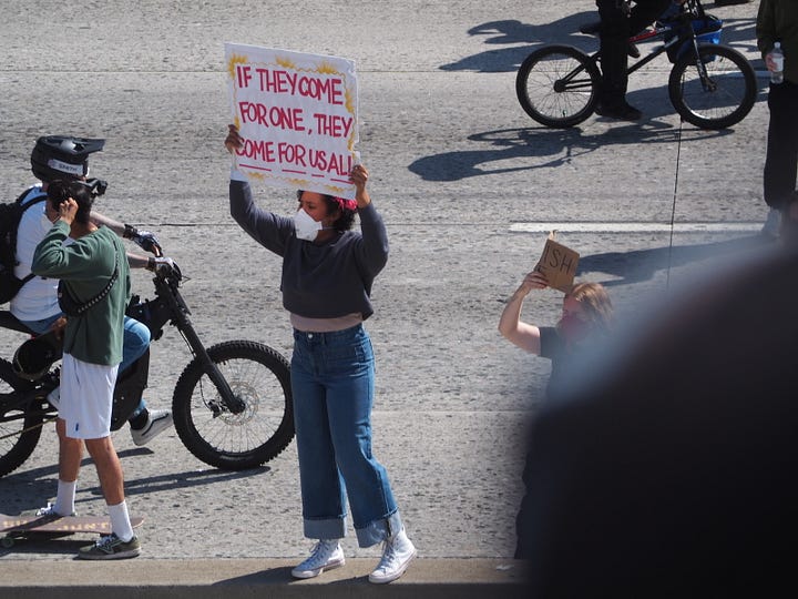 Protesters and California Highway Patrol officers facing each other on the 101 freeway in Los Angeles.